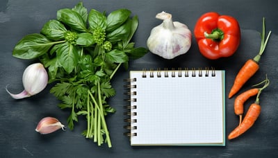 Fresh ingredients and a notepad for recipes